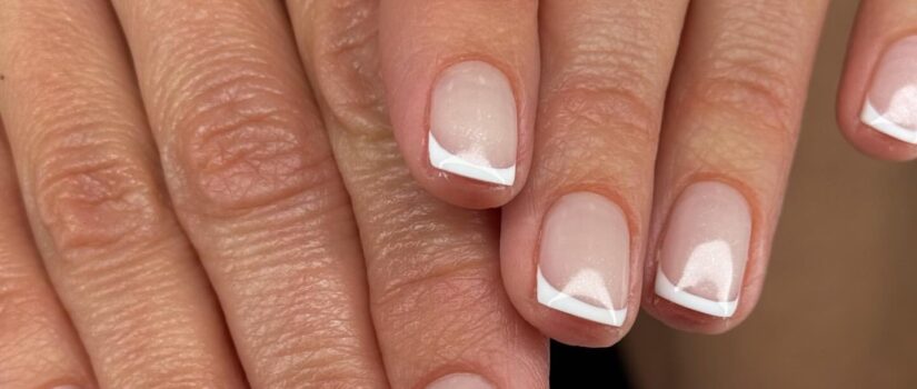 Modern French tip manicure with geometric white tips - winter nail trends Boise 2025